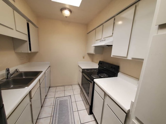 kitchen with under cabinet range hood, a sink, white appliances, light countertops, and light tile patterned floors