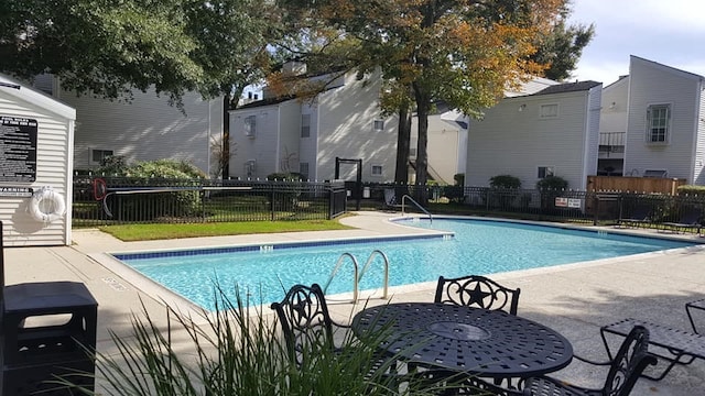 pool featuring a patio area and fence