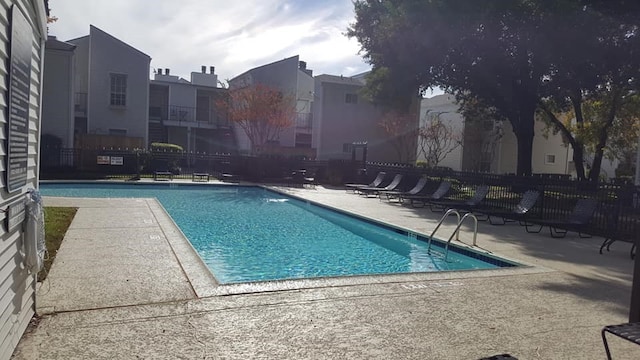 pool with fence and a patio area