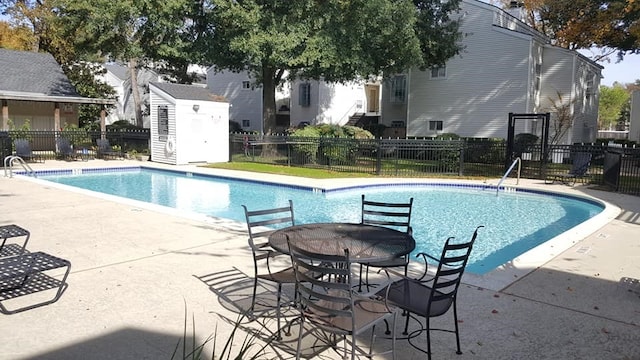 community pool featuring a patio area and fence