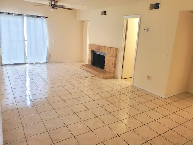 unfurnished living room featuring visible vents, light tile patterned flooring, a fireplace, and a ceiling fan