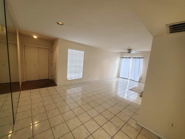 unfurnished room with light tile patterned flooring and visible vents