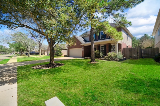 traditional home featuring brick siding, fence, a front yard, a garage, and driveway