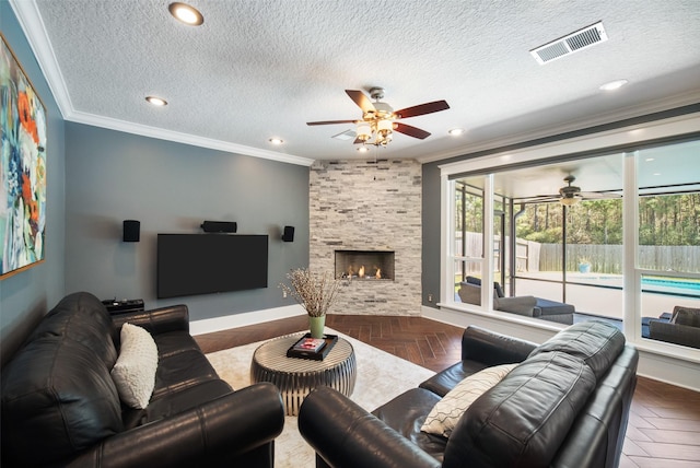 living area featuring crown molding, a ceiling fan, and visible vents