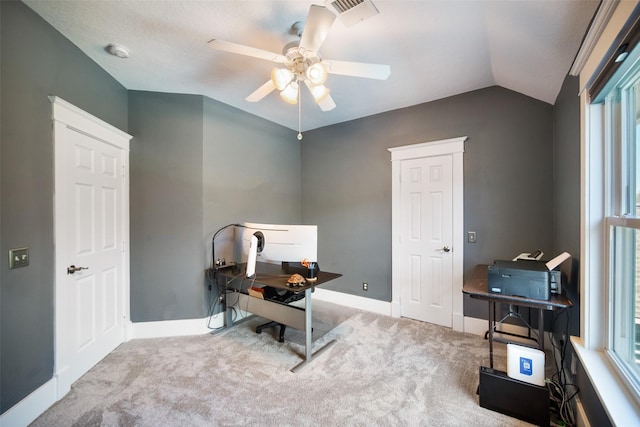 carpeted home office featuring a wealth of natural light, baseboards, a ceiling fan, and vaulted ceiling