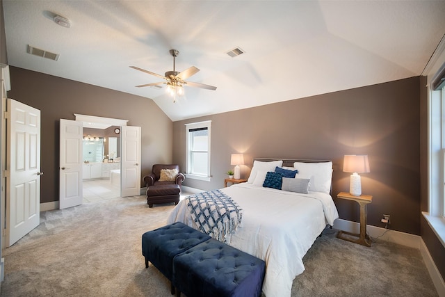 bedroom with lofted ceiling, visible vents, and light carpet