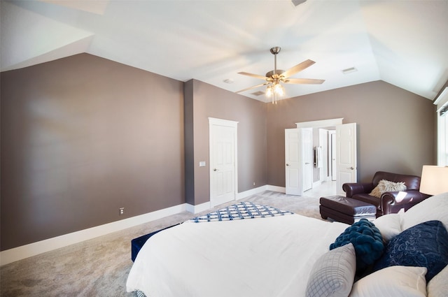 bedroom featuring light carpet, a ceiling fan, baseboards, and vaulted ceiling