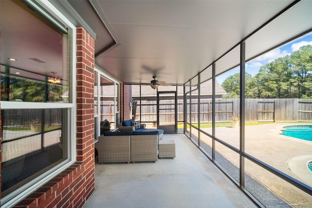 sunroom featuring ceiling fan