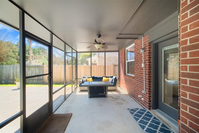 unfurnished sunroom featuring ceiling fan