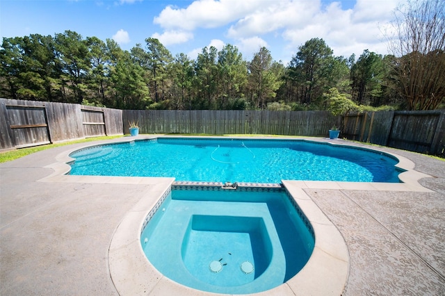 view of swimming pool with a patio, a pool with connected hot tub, and a fenced backyard