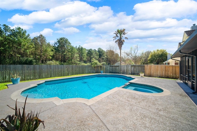 view of swimming pool with a pool with connected hot tub, a fenced backyard, and a patio area