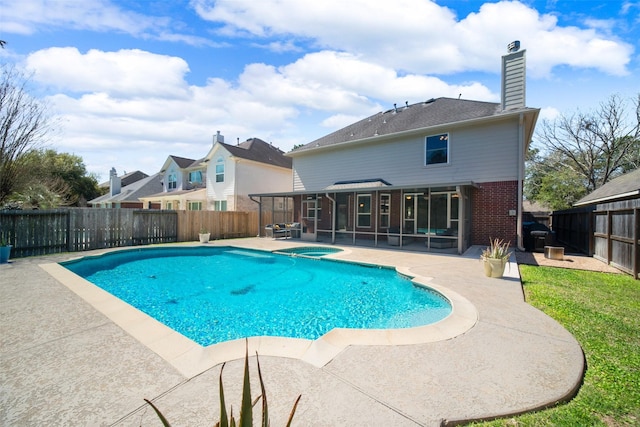 view of swimming pool featuring a fenced in pool, a sunroom, a fenced backyard, and a patio area