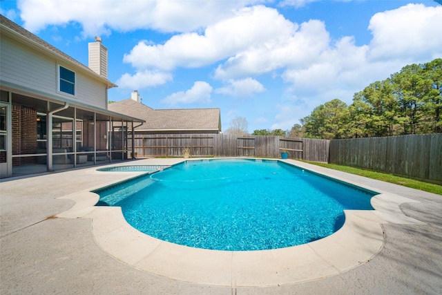 view of swimming pool featuring a patio, a fenced in pool, a fenced backyard, and a sunroom