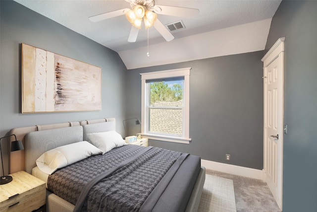 carpeted bedroom featuring visible vents, baseboards, lofted ceiling, and a ceiling fan