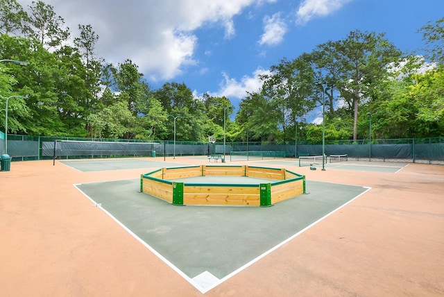 view of tennis court with fence