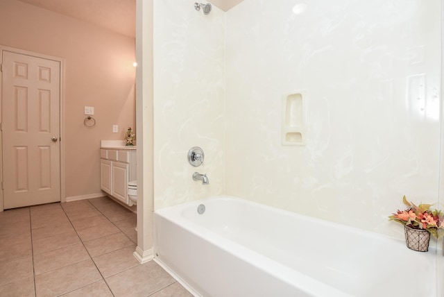 bathroom featuring tile patterned floors, baseboards,  shower combination, and vanity