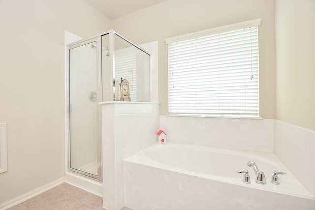 bathroom with tile patterned floors, a garden tub, and a shower stall