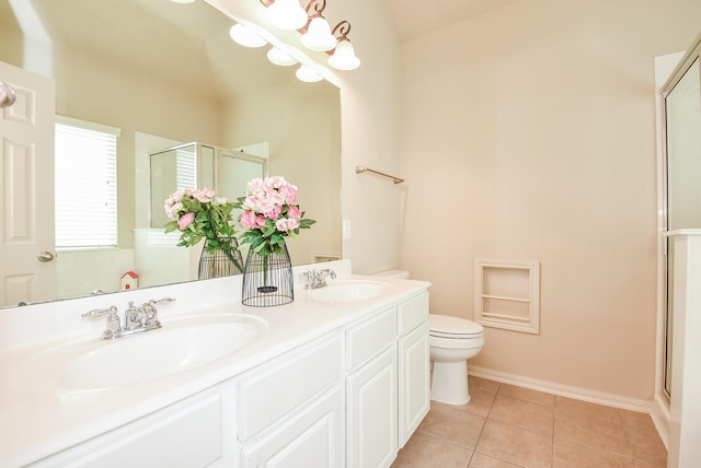 bathroom featuring tile patterned floors, a shower stall, double vanity, and a sink