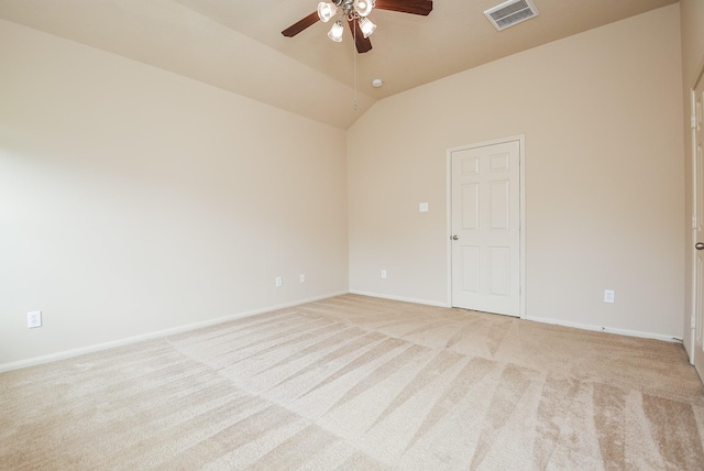 spare room with a ceiling fan, visible vents, baseboards, vaulted ceiling, and light colored carpet