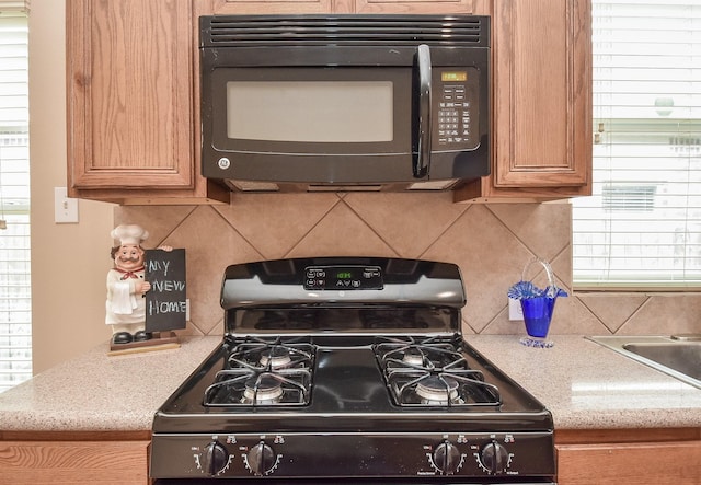 kitchen featuring black appliances and backsplash