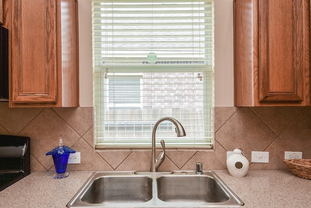 kitchen with light countertops, plenty of natural light, and a sink