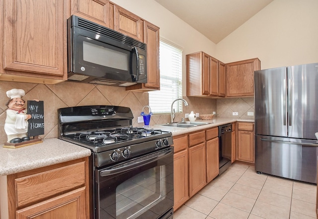 kitchen with black appliances, a sink, light countertops, light tile patterned floors, and lofted ceiling