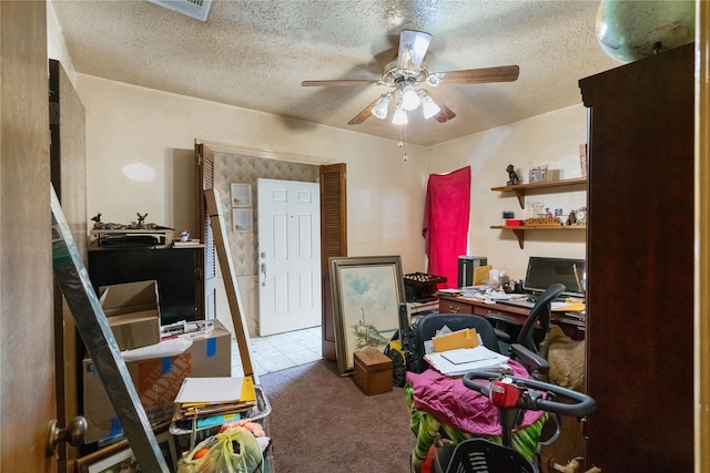 office area featuring visible vents, carpet floors, a textured ceiling, and a ceiling fan