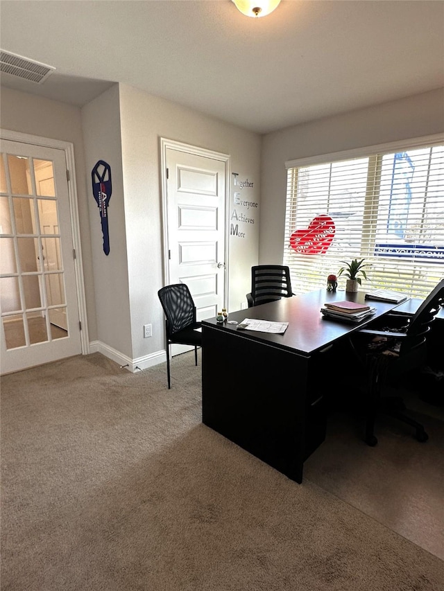 office area featuring carpet flooring, baseboards, and visible vents