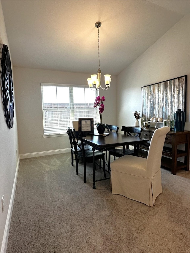 carpeted dining room featuring baseboards, lofted ceiling, and a notable chandelier