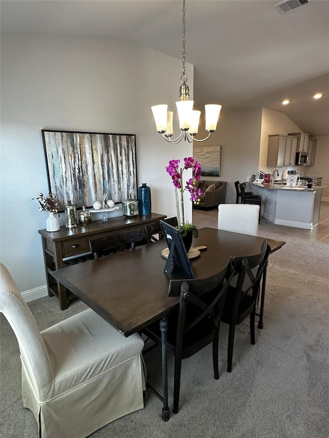 dining space with visible vents, light colored carpet, vaulted ceiling, recessed lighting, and a notable chandelier