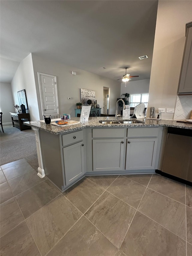 kitchen featuring visible vents, a ceiling fan, light stone counters, a sink, and stainless steel dishwasher