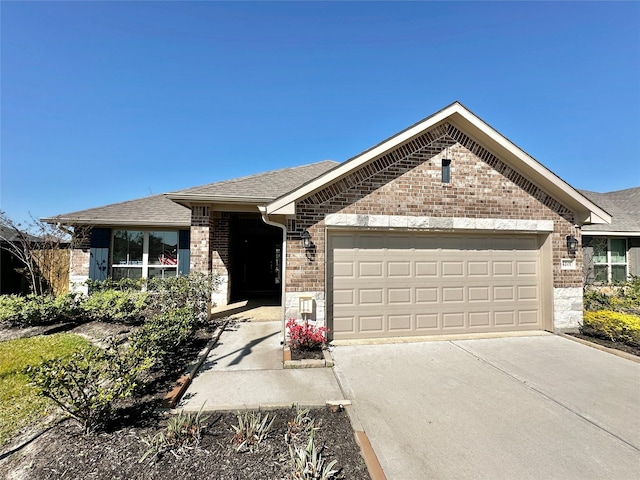 view of front of property featuring concrete driveway, a garage, brick siding, and roof with shingles