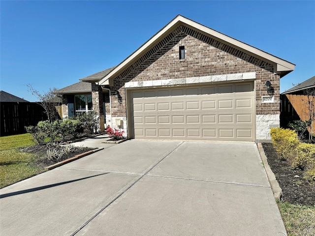 ranch-style house with brick siding, concrete driveway, an attached garage, and fence