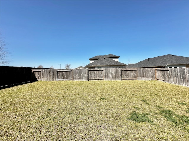 view of yard with a fenced backyard