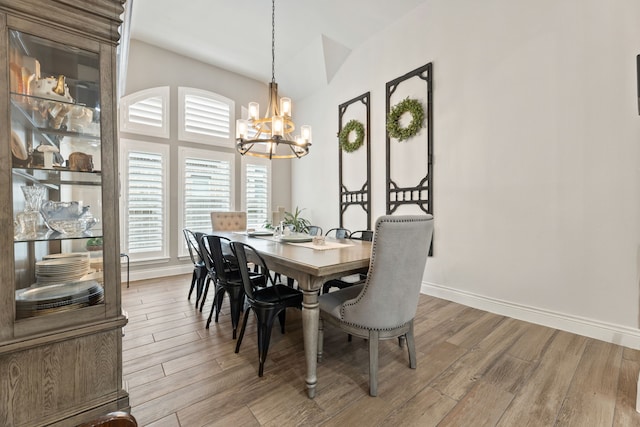 dining area with an inviting chandelier, wood finished floors, and baseboards