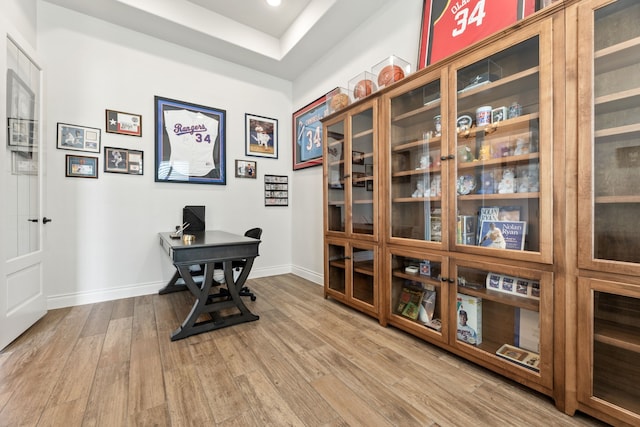 office area with baseboards and wood finished floors