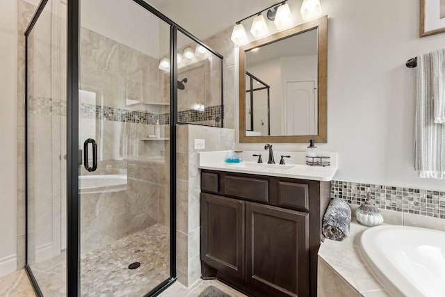 full bathroom with a bath, a stall shower, and vanity