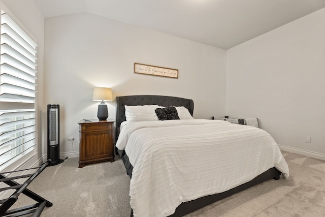 bedroom featuring baseboards, carpet, and vaulted ceiling