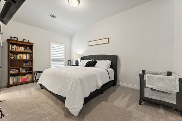 carpeted bedroom with baseboards, lofted ceiling, and visible vents