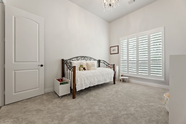 carpeted bedroom with visible vents, baseboards, lofted ceiling, and an inviting chandelier