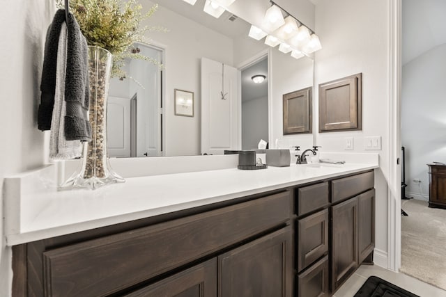 bathroom featuring baseboards, vanity, and tile patterned flooring