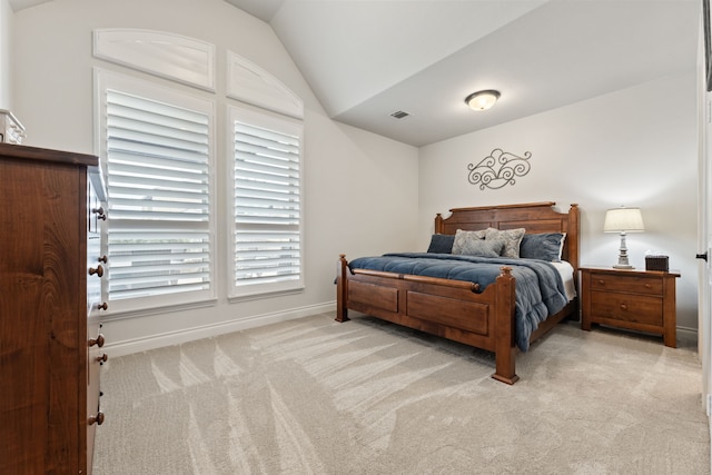 bedroom with light carpet, visible vents, baseboards, and lofted ceiling