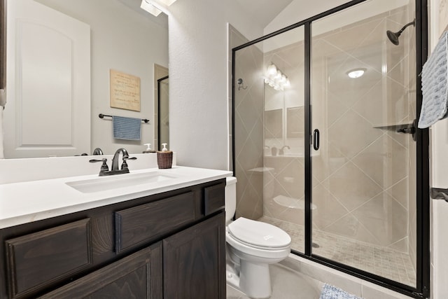 full bath featuring a shower stall, toilet, vanity, and lofted ceiling