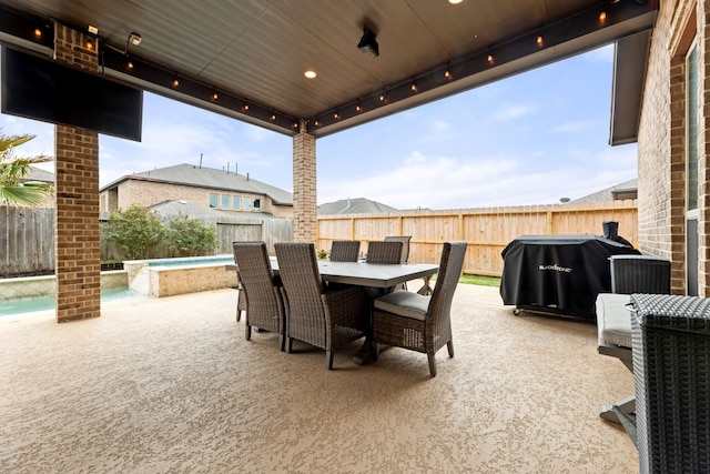 view of patio featuring a fenced in pool, a jacuzzi, outdoor dining area, a fenced backyard, and a grill