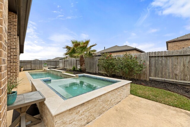 view of pool featuring an in ground hot tub, a fenced backyard, and a patio