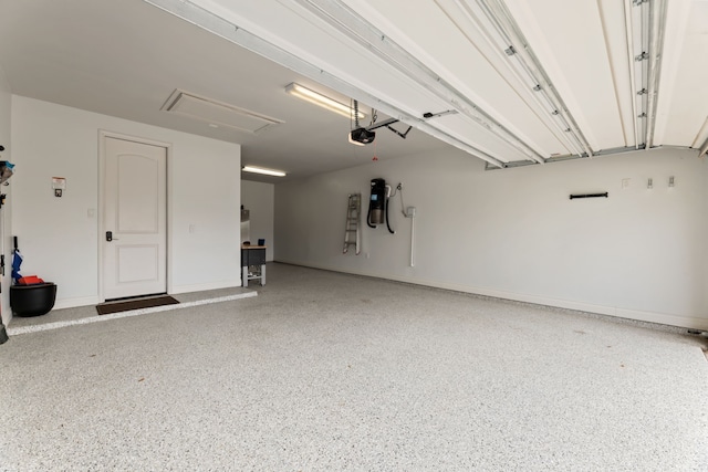 garage with a garage door opener and baseboards