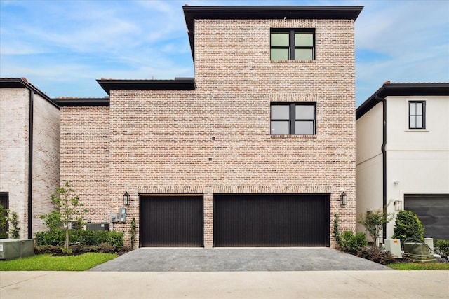 7527 Ciano Ln, Houston, TX 77055 - view of front of home featuring brick siding, driveway, and a garage