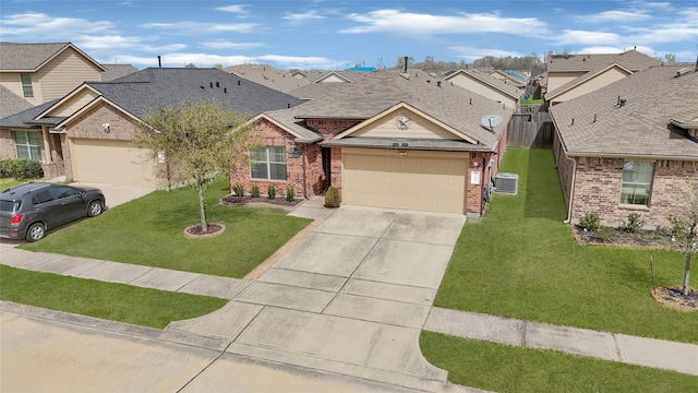 single story home with driveway, a residential view, a front yard, a garage, and brick siding