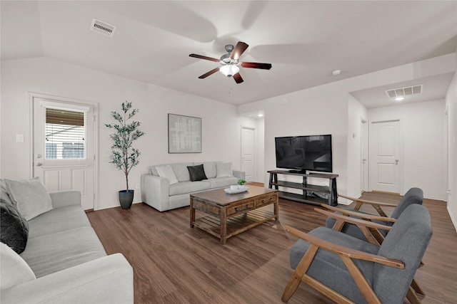 living area with ceiling fan, visible vents, dark wood-style floors, and vaulted ceiling