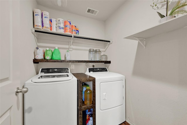 laundry area with washing machine and clothes dryer, laundry area, and visible vents